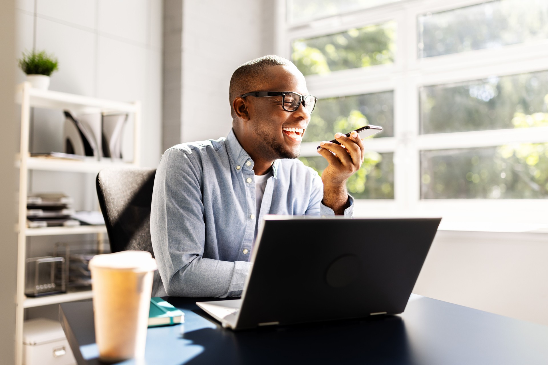 Smiling African American Salesman Making a Business Call on Smartphone