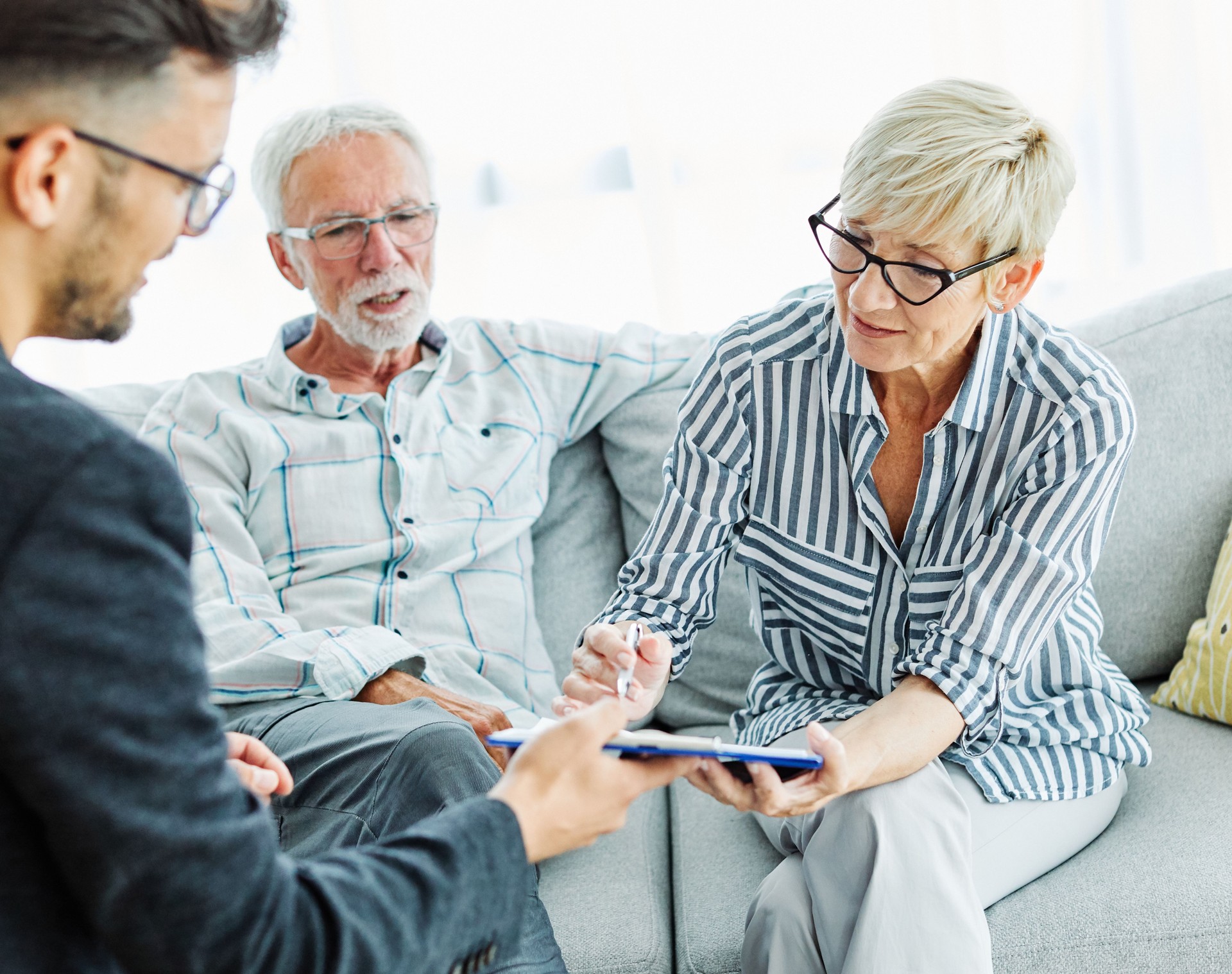 contract signing senior couple document investment business finance agent meeting agreement home