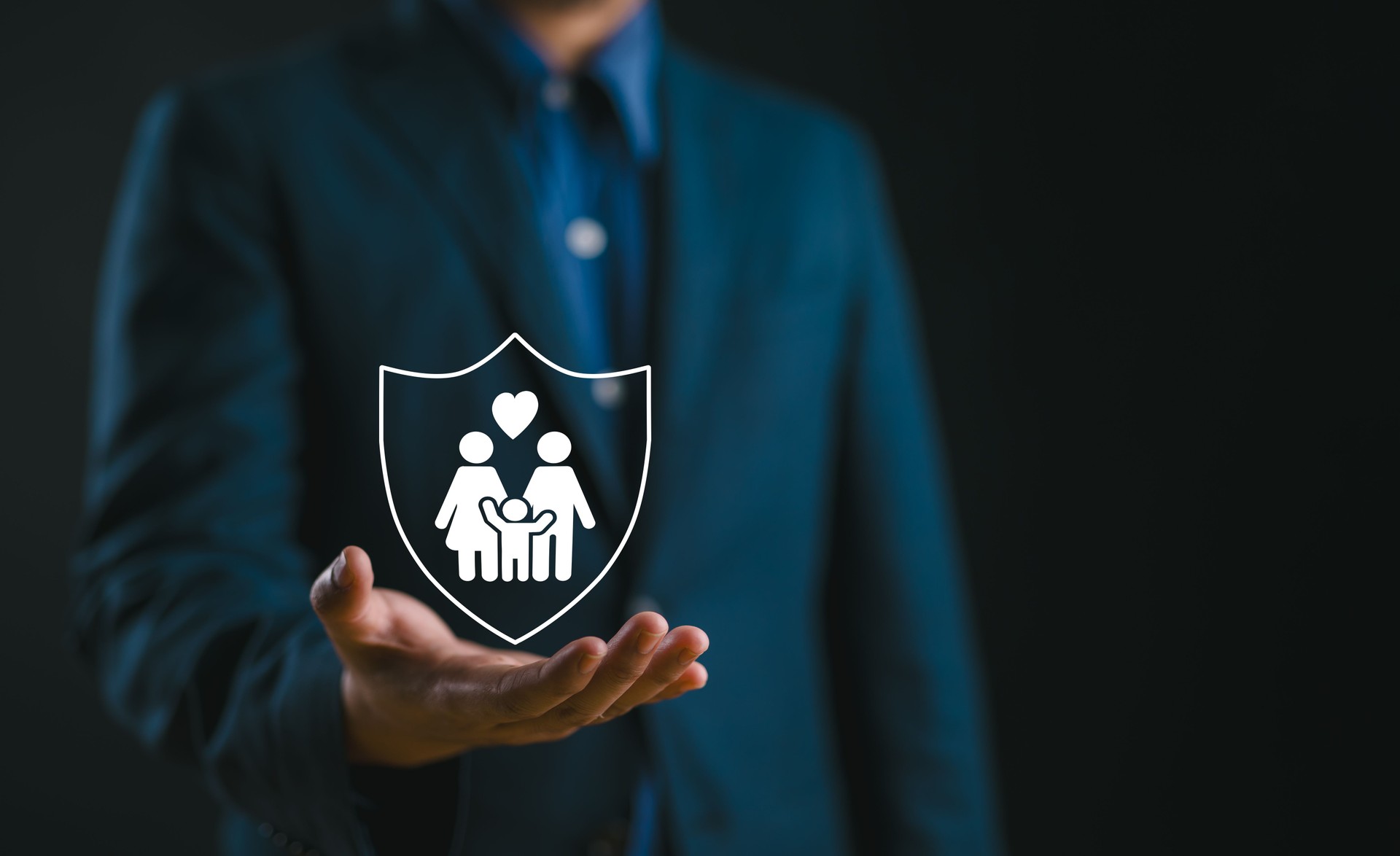 Supporting family futures, Businessman protective gesture complements young family silhouette. Health and house insurance icons symbolize protection, reinforcing family life insurance.